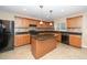 A view of the kitchen boasting an island, granite countertops, and sleek appliances at 617 Conover Rd, Durham, NC 27703