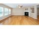Bright living room with hardwood floors, large windows, and a fireplace at 617 Conover Rd, Durham, NC 27703