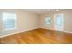 Empty living room with sleek hardwood floors, neutral walls, and bright windows for ample natural light at 617 Conover Rd, Durham, NC 27703