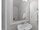 Neutral bathroom with a framed mirror, sink and brushed nickel faucet, plus a white towel at 633 Democracy St, Raleigh, NC 27603