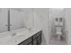 Bathroom featuring a double sink, a large mirror, and a shower with glass door at 633 Democracy St, Raleigh, NC 27603