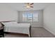 Bright bedroom with a large window, ceiling fan, and carpeting, offers a serene retreat at 633 Democracy St, Raleigh, NC 27603