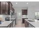 Modern kitchen with stainless steel appliances, granite countertops, and ample cabinet space at 633 Democracy St, Raleigh, NC 27603
