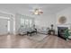 Bright living room with hardwood floors, fireplace, and large windows that provide plenty of natural light at 633 Democracy St, Raleigh, NC 27603