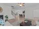 Open-concept living room with hardwood floors, fireplace, and stairs leading to the upper level at 633 Democracy St, Raleigh, NC 27603