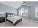 Bedroom features a ceiling fan, cathedral ceiling, carpeting, and a large window at 633 Democracy St, Raleigh, NC 27603