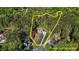 Aerial view showcasing the property lines of a beautiful home nestled among lush greenery and mature trees at 64 Thousand Oaks Ct, Clayton, NC 27527