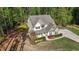 Stunning aerial view of a two-story home with beautiful landscaping and a sprawling yard surrounded by trees at 64 Thousand Oaks Ct, Clayton, NC 27527