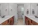 Bathroom with double vanity, brown cabinets, and a door leading to separate toilet area at 64 Thousand Oaks Ct, Clayton, NC 27527