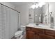 Bathroom featuring a shower with curtain, wood vanity, and white fixtures at 64 Thousand Oaks Ct, Clayton, NC 27527