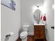 Bathroom featuring a wood vanity, oval mirror, and white fixtures at 64 Thousand Oaks Ct, Clayton, NC 27527