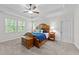 Bright bedroom featuring a ceiling fan, and a wooden bed frame with stylish bedside tables at 64 Thousand Oaks Ct, Clayton, NC 27527