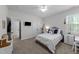 Comfortable bedroom featuring a ceiling fan, TV, and a cozy bed with ample natural light at 64 Thousand Oaks Ct, Clayton, NC 27527