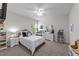 Inviting bedroom featuring white walls, a ceiling fan, a bed, and carpet at 64 Thousand Oaks Ct, Clayton, NC 27527