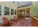 Outdoor deck featuring ample seating with a screened-in porch and wooded backyard at 64 Thousand Oaks Ct, Clayton, NC 27527
