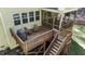 Wooden deck with a grill and outdoor seating, plus access to a screened-in porch at 64 Thousand Oaks Ct, Clayton, NC 27527