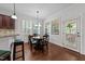 Cozy dining area with a breakfast bar, wooden chairs, and natural light at 64 Thousand Oaks Ct, Clayton, NC 27527