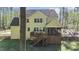 Back of the home with a deck and screened porch, showcasing a spacious backyard at 64 Thousand Oaks Ct, Clayton, NC 27527