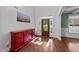 Bright foyer featuring hardwood floors, a stylish cabinet, and a welcoming front door at 64 Thousand Oaks Ct, Clayton, NC 27527