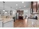 Kitchen with stainless appliances, granite countertops, and wood floors at 64 Thousand Oaks Ct, Clayton, NC 27527