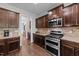 Kitchen showcasing stainless appliances, granite counters, tile backsplash, and wood floors at 64 Thousand Oaks Ct, Clayton, NC 27527