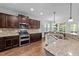 Bright kitchen featuring granite counters, stainless appliances, and wood floors at 64 Thousand Oaks Ct, Clayton, NC 27527