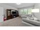 Inviting living room with a large sectional, entertainment center, and sunlit windows at 64 Thousand Oaks Ct, Clayton, NC 27527