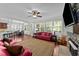 Inviting living room with large windows, a stone fireplace, and hardwood floors at 64 Thousand Oaks Ct, Clayton, NC 27527