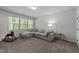 Spacious living room boasting natural light and a comfortable sectional couch for relaxation at 64 Thousand Oaks Ct, Clayton, NC 27527