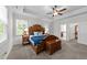 Main bedroom featuring a tray ceiling, wood furniture, and carpet floors at 64 Thousand Oaks Ct, Clayton, NC 27527