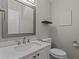 Elegant half bath with white vanity, modern faucet, and a stylish square mirror at 6568 English Oaks Dr, Raleigh, NC 27615
