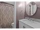 Bathroom with marble vanity, decorative shower curtain, and oval mirror at 6568 English Oaks Dr, Raleigh, NC 27615
