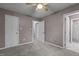 Bedroom featuring neutral walls, carpet, ceiling fan, and multiple doors at 6568 English Oaks Dr, Raleigh, NC 27615