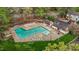 Aerial view of the outdoor community pool, surrounded by trees, and seating at 6568 English Oaks Dr, Raleigh, NC 27615
