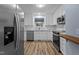 Contemporary kitchen featuring stainless steel appliances, white cabinetry, and modern fixtures at 6568 English Oaks Dr, Raleigh, NC 27615