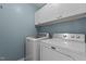 Convenient laundry area with white cabinets, washer, and dryer at 6568 English Oaks Dr, Raleigh, NC 27615