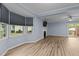 Bright living room with large windows, stylish flooring, and a cozy fireplace at 6568 English Oaks Dr, Raleigh, NC 27615