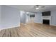Bright living room with fireplace, ceiling fan, and beautiful wood-look flooring at 6568 English Oaks Dr, Raleigh, NC 27615