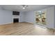 Comfortable living room with a fireplace, sliding glass doors, and wood-style laminate flooring at 6568 English Oaks Dr, Raleigh, NC 27615