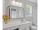 Bathroom featuring vanity with modern fixtures, framed mirror, and natural light from the window at 6863 Paint Rock Ln, Raleigh, NC 27610