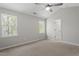 Bright bedroom features neutral walls, carpeting, ceiling fan and multiple windows at 6863 Paint Rock Ln, Raleigh, NC 27610