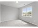 Cozy bedroom features neutral paint and carpet, offering a comfortable space with great natural light from the large window at 6863 Paint Rock Ln, Raleigh, NC 27610