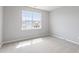 Comfortable bedroom with neutral paint and carpet with a large window that offers natural light at 6863 Paint Rock Ln, Raleigh, NC 27610