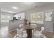 Cozy dining area with ample natural light from window, complemented by a round table and white chairs at 6863 Paint Rock Ln, Raleigh, NC 27610