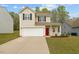 Charming two-story home featuring a well-maintained lawn, a two-car garage, and a welcoming front porch at 6863 Paint Rock Ln, Raleigh, NC 27610