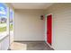 Inviting front porch features a vibrant red door and complements the home's light-colored exterior at 6863 Paint Rock Ln, Raleigh, NC 27610