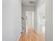 Hallway with stairs and entry doors features updated flooring and neutral wall colors at 6863 Paint Rock Ln, Raleigh, NC 27610