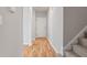 Hallway with stairs and entry door features updated flooring and neutral wall colors at 6863 Paint Rock Ln, Raleigh, NC 27610
