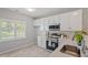 Modern kitchen featuring white cabinets, stainless steel appliances, and bright natural light at 6863 Paint Rock Ln, Raleigh, NC 27610