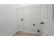 Functional laundry room features shelving, connections for washer and dryer, and easy-to-clean flooring at 6863 Paint Rock Ln, Raleigh, NC 27610